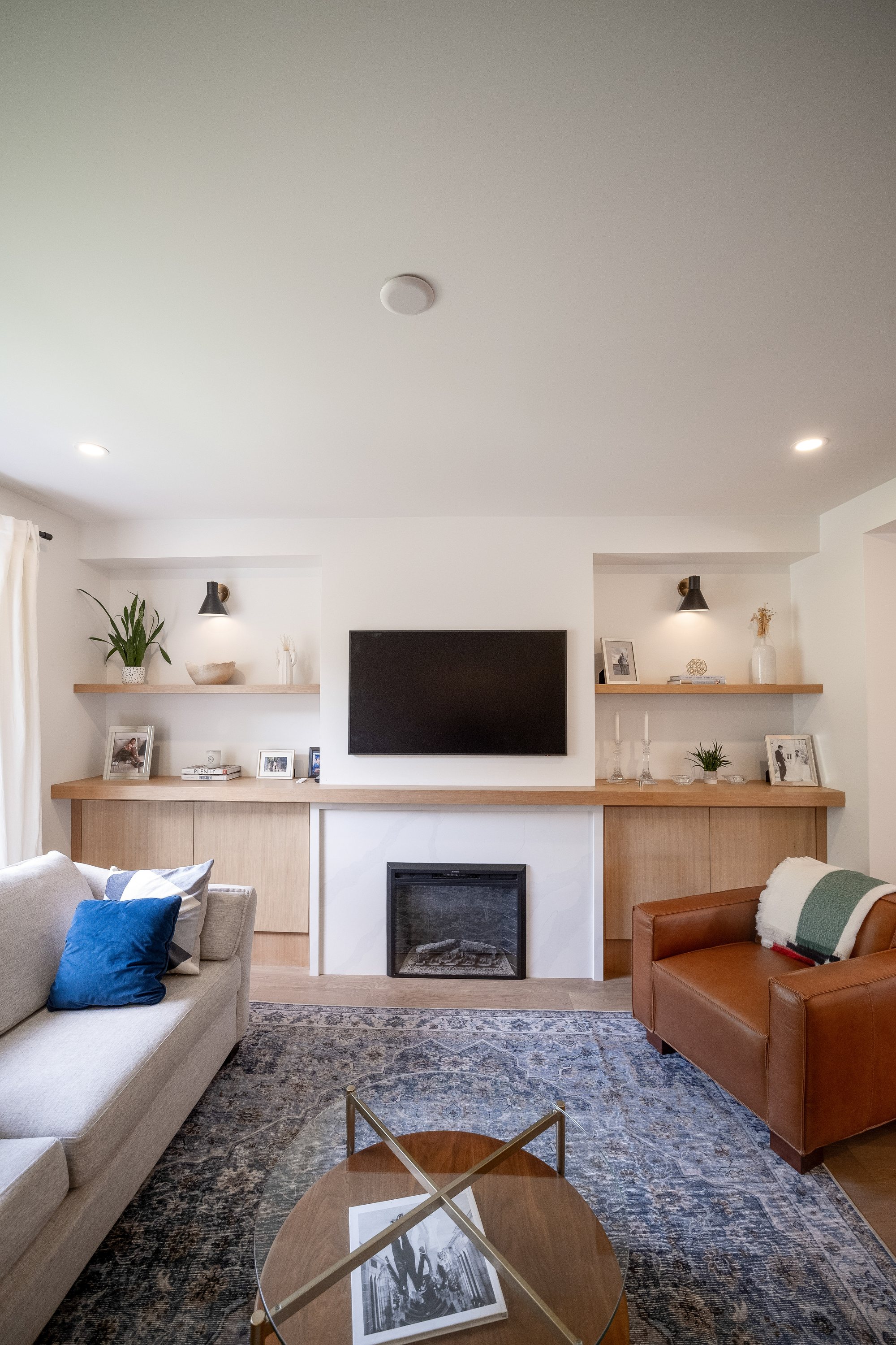Living room with white oak built-ins and fireplace wall, High Park renovation, Toronto, by Doty Design & Build